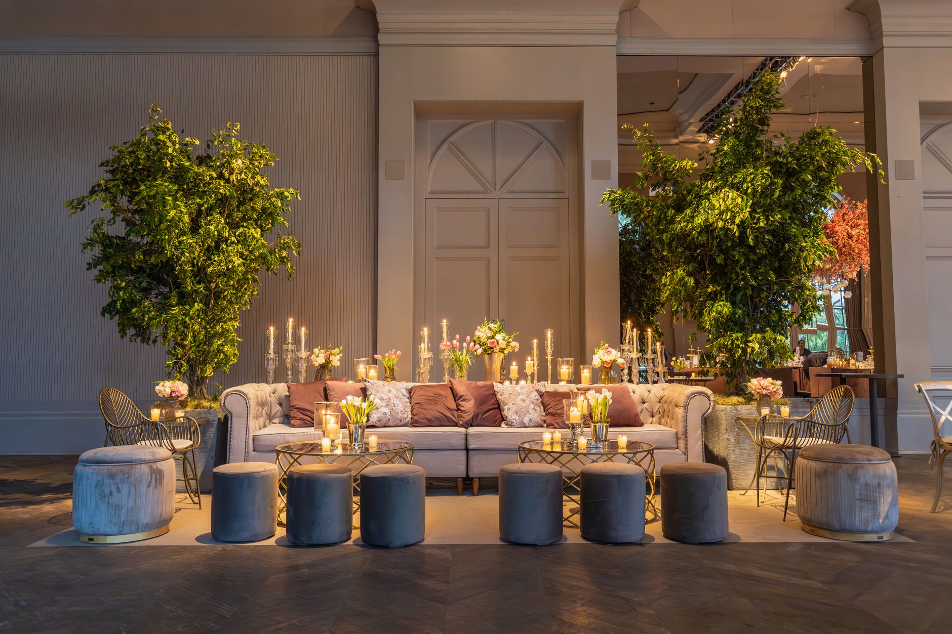 Stylish lounge setup with plush sofa, candles, and lush greenery indoors. — "MDF Cut to Size for Precise Project Requirements